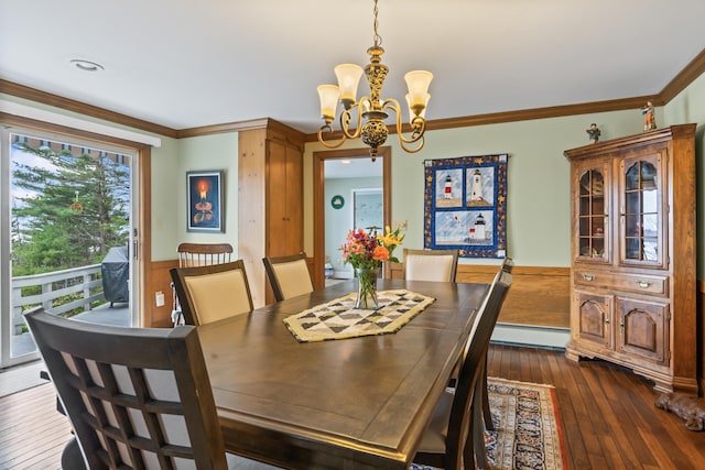 dining room featuring crown molding, an inviting chandelier, wainscoting, and a baseboard radiator