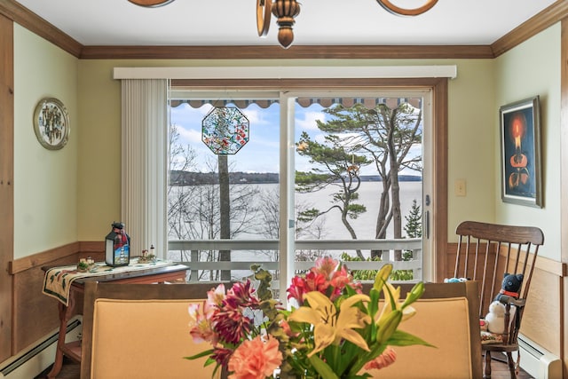 dining area featuring a water view, crown molding, and a baseboard radiator