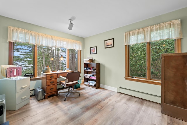 office featuring a baseboard radiator, light wood-style flooring, and baseboards