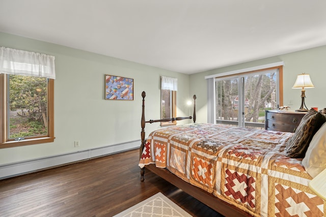 bedroom featuring a baseboard heating unit and wood finished floors