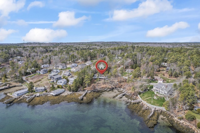 bird's eye view with a forest view and a water view