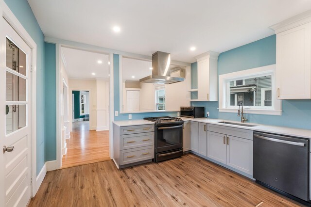 32 Webster Ave, Bangor, ME 04401 - kitchen with a sink, light wood-style floors, stainless steel appliances, island exhaust hood, and gray cabinets