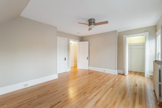 32 Webster Ave, Bangor, ME 04401 - unfurnished bedroom featuring heating unit, a closet, light wood finished floors, baseboards, and a ceiling fan