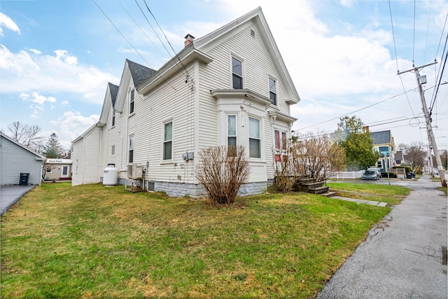 32 Webster Ave, Bangor, ME 04401 - view of side of home featuring a chimney and a yard