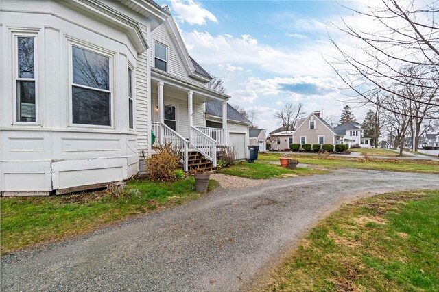 32 Webster Ave, Bangor, ME 04401 - view of property exterior featuring driveway, a porch, and a residential view