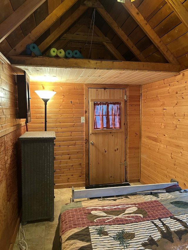bedroom featuring vaulted ceiling with beams, wooden walls, and wooden ceiling