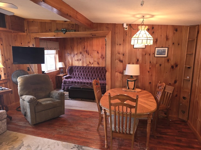 dining space featuring wood walls and hardwood / wood-style floors