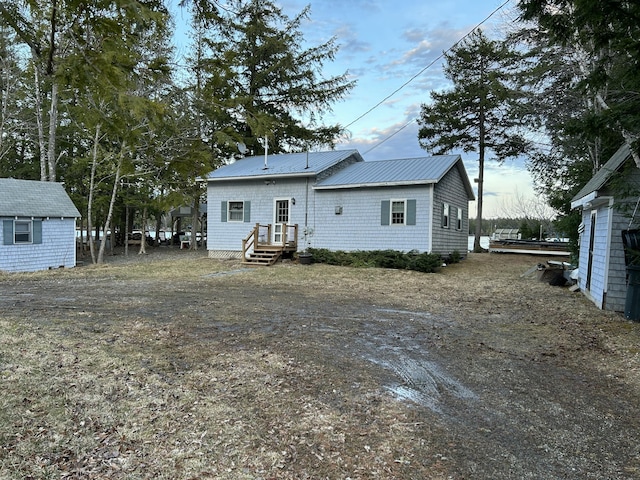 rear view of house with metal roof