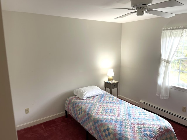 carpeted bedroom with ceiling fan, baseboard heating, and baseboards