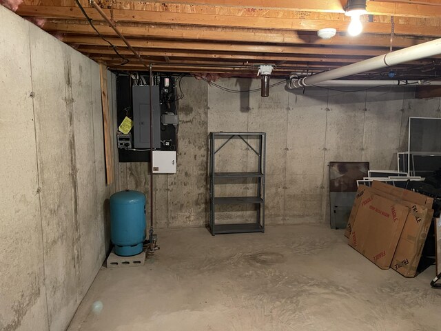 unfinished basement featuring electric panel