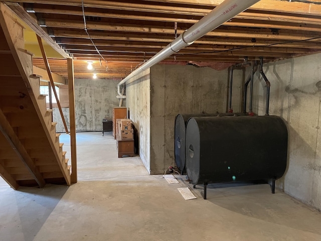 unfinished below grade area featuring stairs and heating fuel