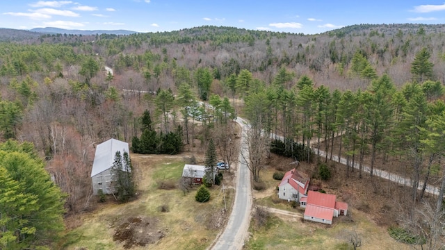 birds eye view of property featuring a mountain view and a forest view