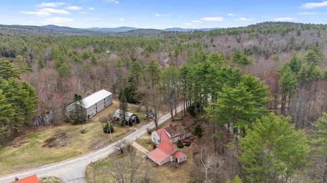 birds eye view of property with a mountain view and a view of trees