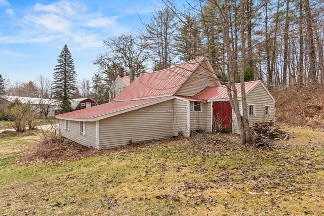 view of side of property featuring metal roof