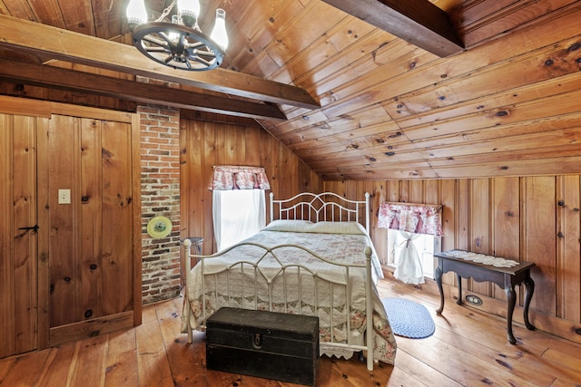 bedroom with lofted ceiling with beams, hardwood / wood-style floors, wood walls, and wood ceiling