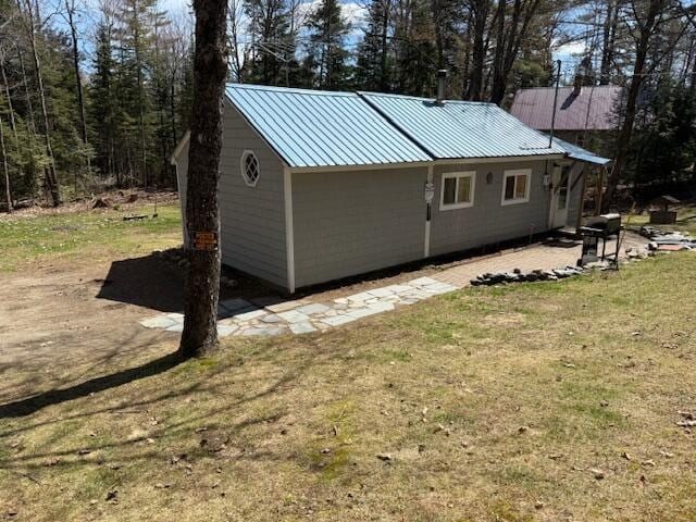 exterior space with a yard and metal roof