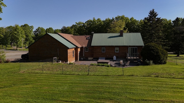 129 Ledge Hill Rd, Corinth, ME 04427 - back of property featuring a chimney, metal roof, and view of scattered trees