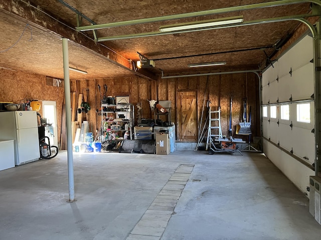 129 Ledge Hill Rd, Corinth, ME 04427 - garage with freestanding refrigerator and a garage door opener