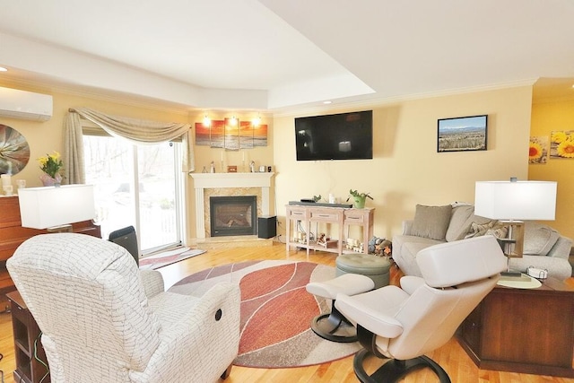 living room with a premium fireplace, ornamental molding, and wood finished floors