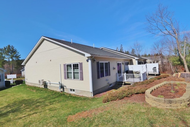 view of side of property with a lawn and a deck