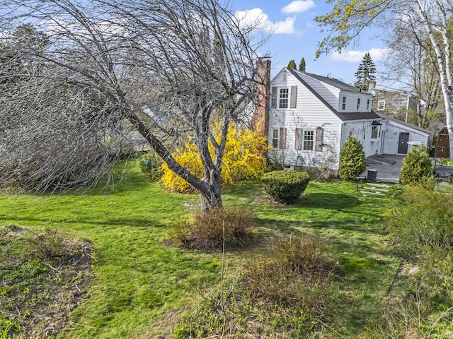 17 US Route 1, Falmouth, ME 04105 - view of side of home featuring a chimney and a yard