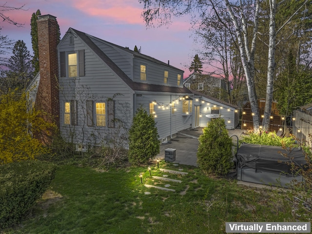 17 US Route 1, Falmouth, ME 04105 - back of property at dusk featuring a chimney and a yard