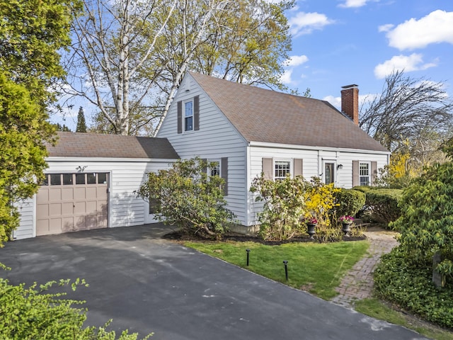 17 US Route 1, Falmouth, ME 04105 - cape cod house featuring an attached garage, a chimney, asphalt driveway, and roof with shingles