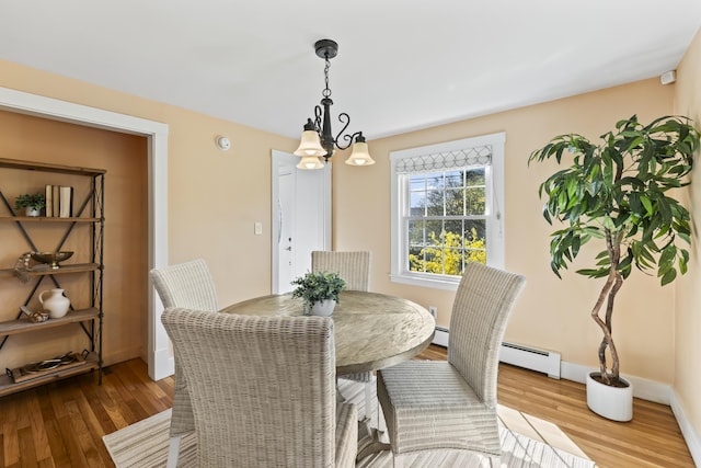 17 US Route 1, Falmouth, ME 04105 - dining room with wood finished floors, a chandelier, baseboards, and a baseboard radiator