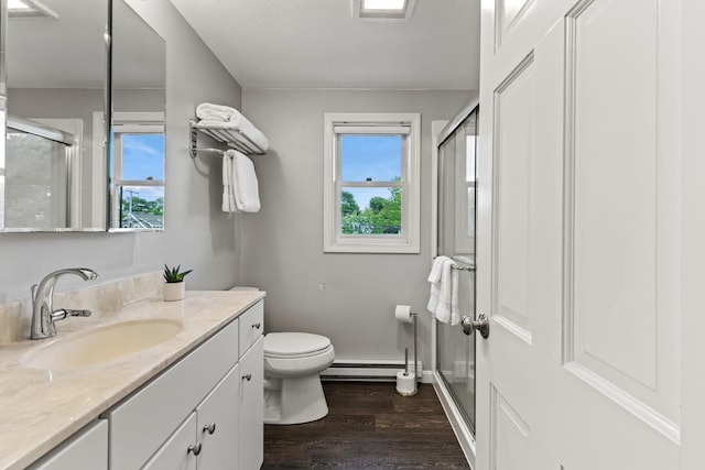 21 Valley St Unit 1, South Portland, ME 04106 - bathroom featuring vanity, wood finished floors, a shower stall, and plenty of natural light