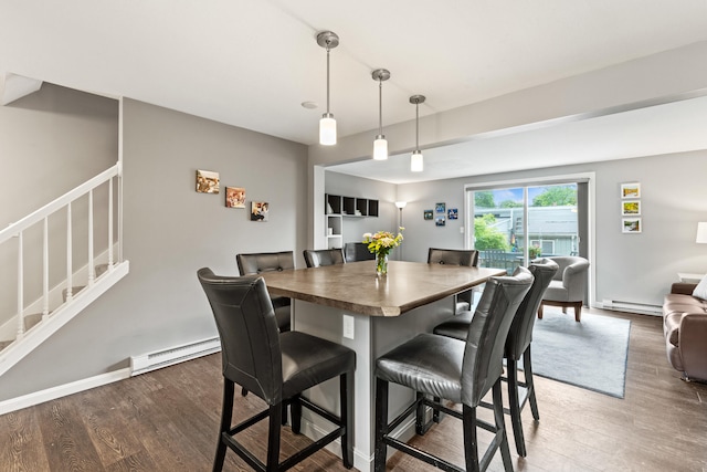 21 Valley St Unit 1, South Portland, ME 04106 - dining space featuring wood finished floors, a baseboard heating unit, and stairs
