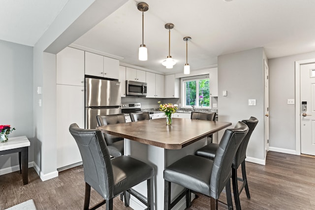 21 Valley St Unit 1, South Portland, ME 04106 - dining area with dark wood-style floors and baseboards