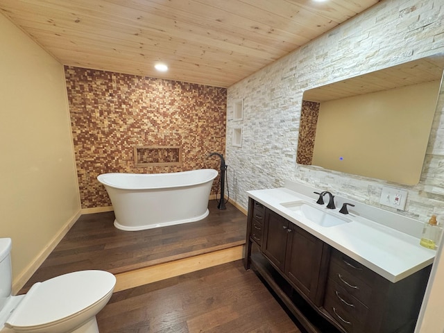 full bath featuring a freestanding tub, wood finished floors, wooden ceiling, vanity, and toilet