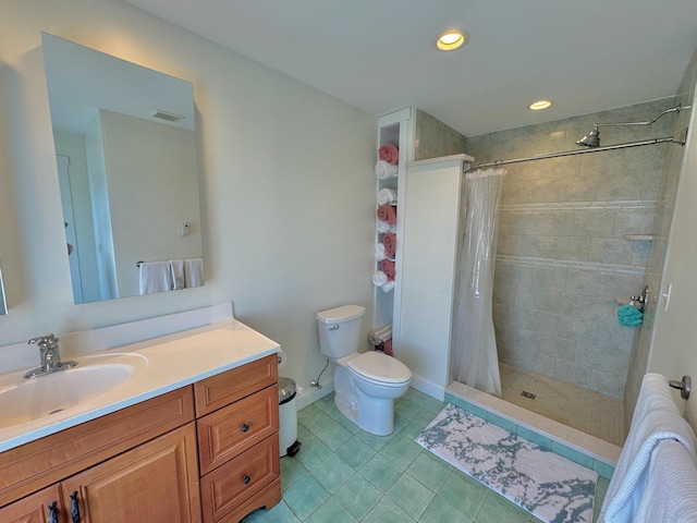 full bathroom with toilet, visible vents, a tile shower, and vanity