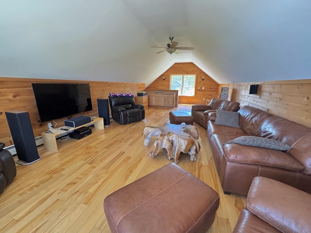 living area with hardwood / wood-style flooring, wood walls, and lofted ceiling