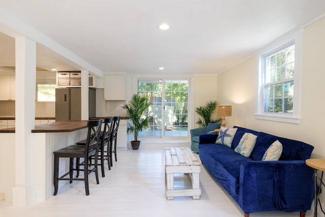 living room with light wood finished floors and recessed lighting
