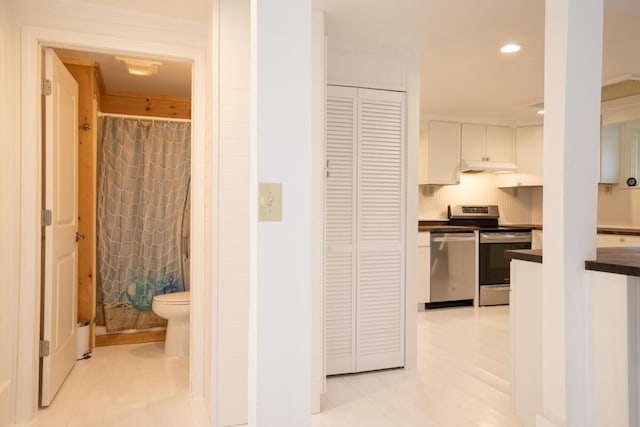 hall with recessed lighting and light tile patterned floors
