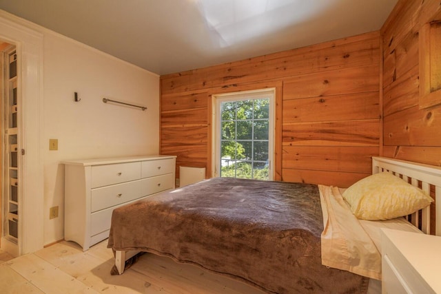 bedroom featuring wood walls