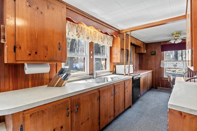 kitchen with a sink, wooden walls, and light countertops