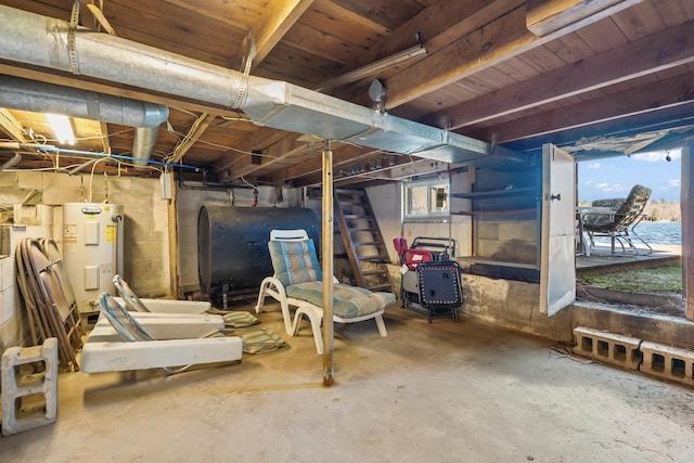 basement with heating fuel, water heater, and stairway