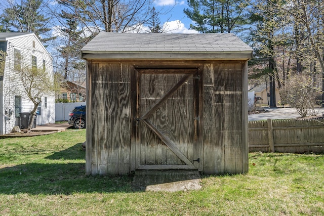 view of shed featuring fence