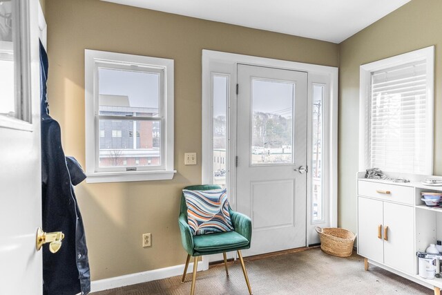 doorway to outside featuring baseboards