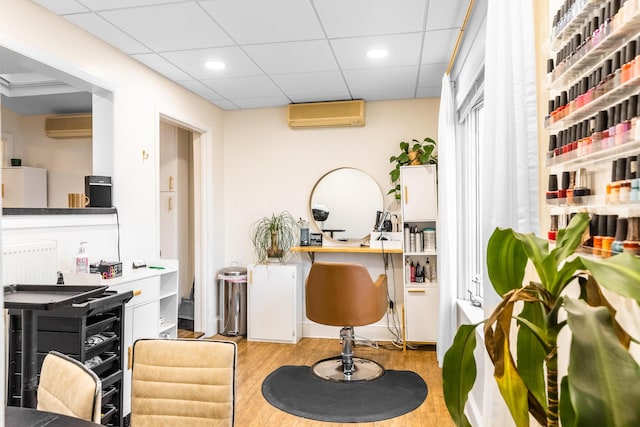 interior space featuring recessed lighting, a wall mounted AC, wood finished floors, and radiator