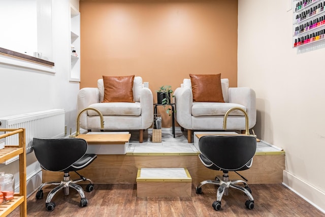 living area featuring baseboards and wood finished floors