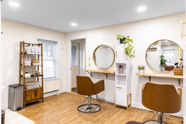 sitting room with recessed lighting, baseboards, radiator heating unit, and light wood finished floors