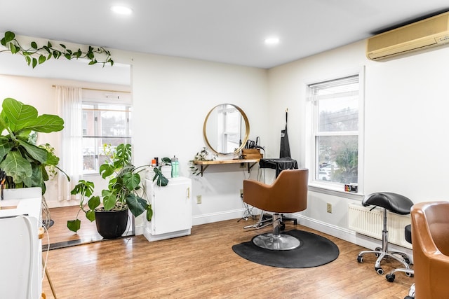 interior space featuring wood finished floors, recessed lighting, baseboards, and a wall mounted AC