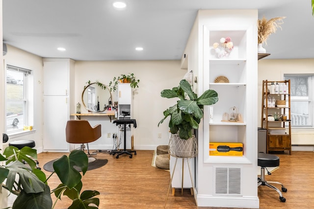 interior space featuring a wealth of natural light, wood finished floors, and visible vents