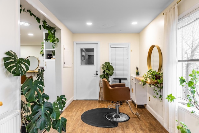 entryway with recessed lighting, baseboards, wood finished floors, and radiator