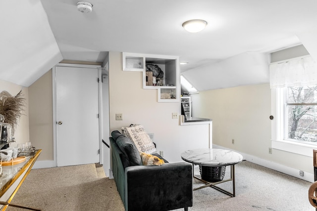 interior space featuring baseboards, light carpet, and lofted ceiling
