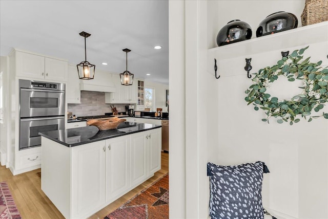 kitchen featuring white cabinetry, appliances with stainless steel finishes, and light wood-style floors