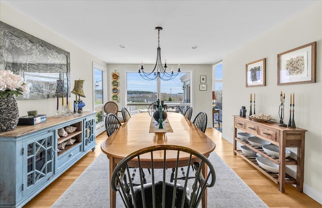 dining room featuring plenty of natural light, recessed lighting, light wood-style flooring, and a chandelier
